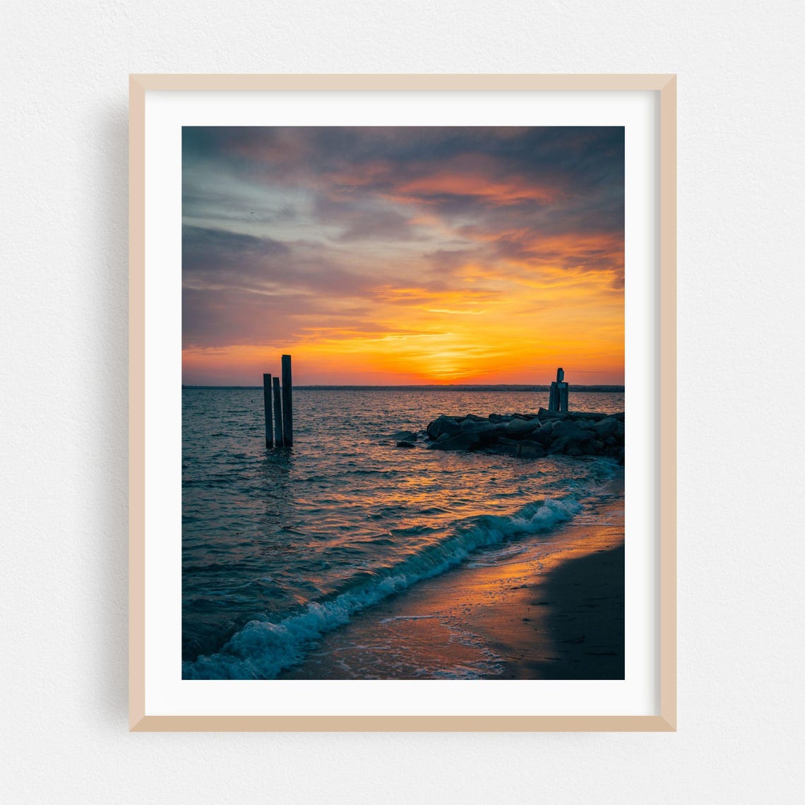 Sunset Over Ocean With Old Pier Posts And Rocky Jetty Poster