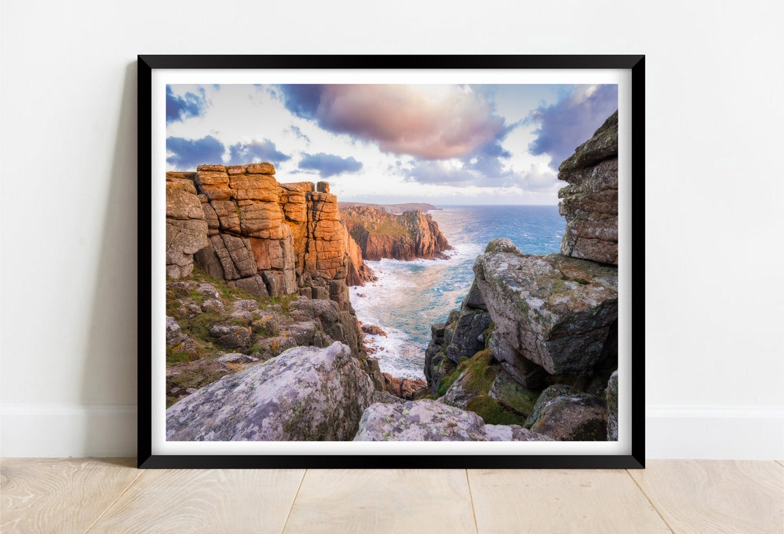 Towering Granite Sea Cliffs Bathed in Warm Golden Light Poster