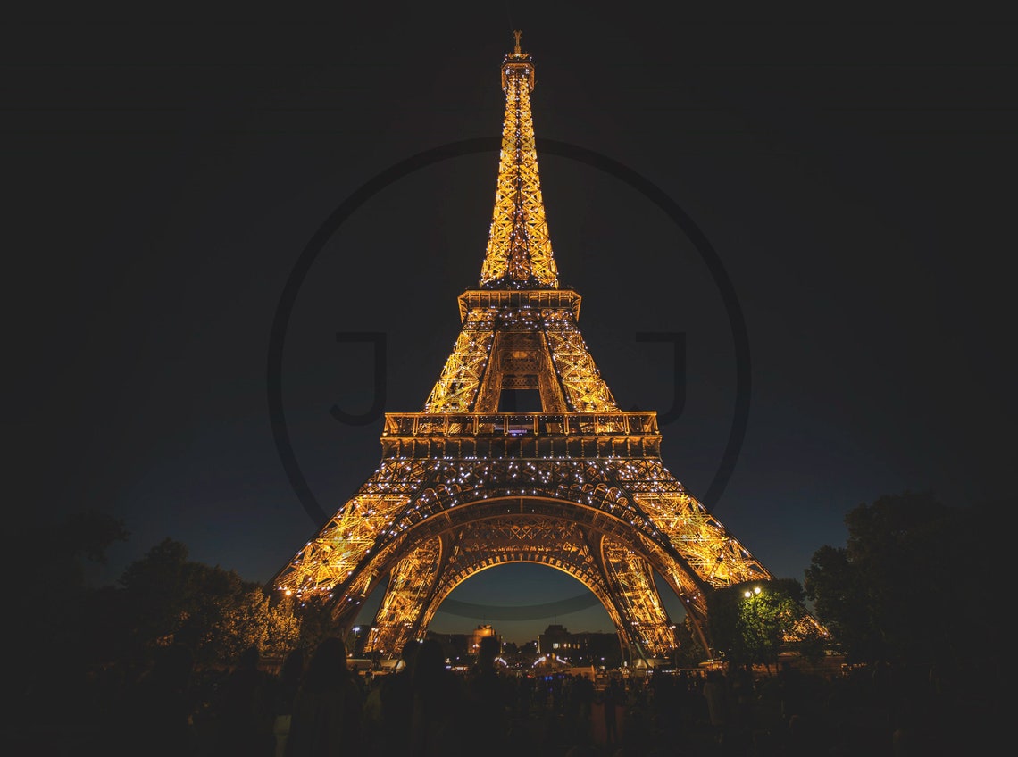 Eiffel Tower Illuminated in Gold Lights at Night in Paris Poster - Image 3