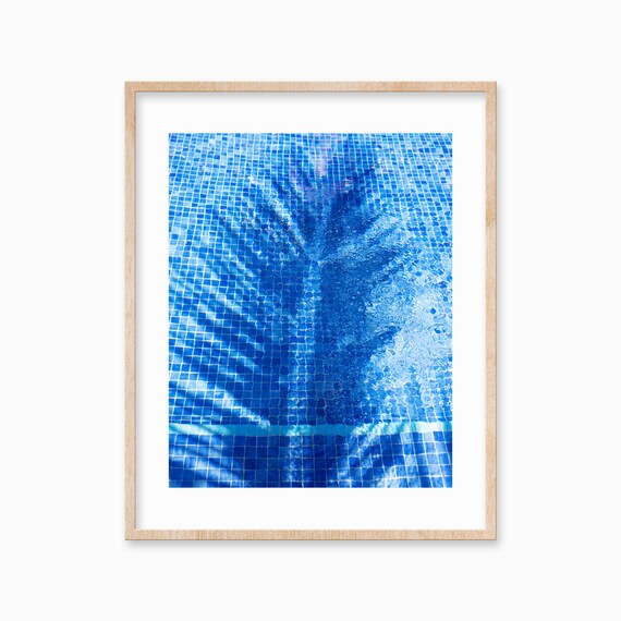 Palm Tree Shadow Dancing on a Blue Tiled Swimming Pool Poster