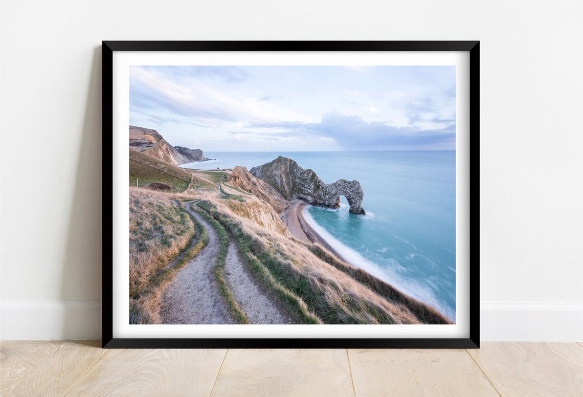 Durdle Door Limestone Arch With a Winding Coastal Path at Dawn Poster