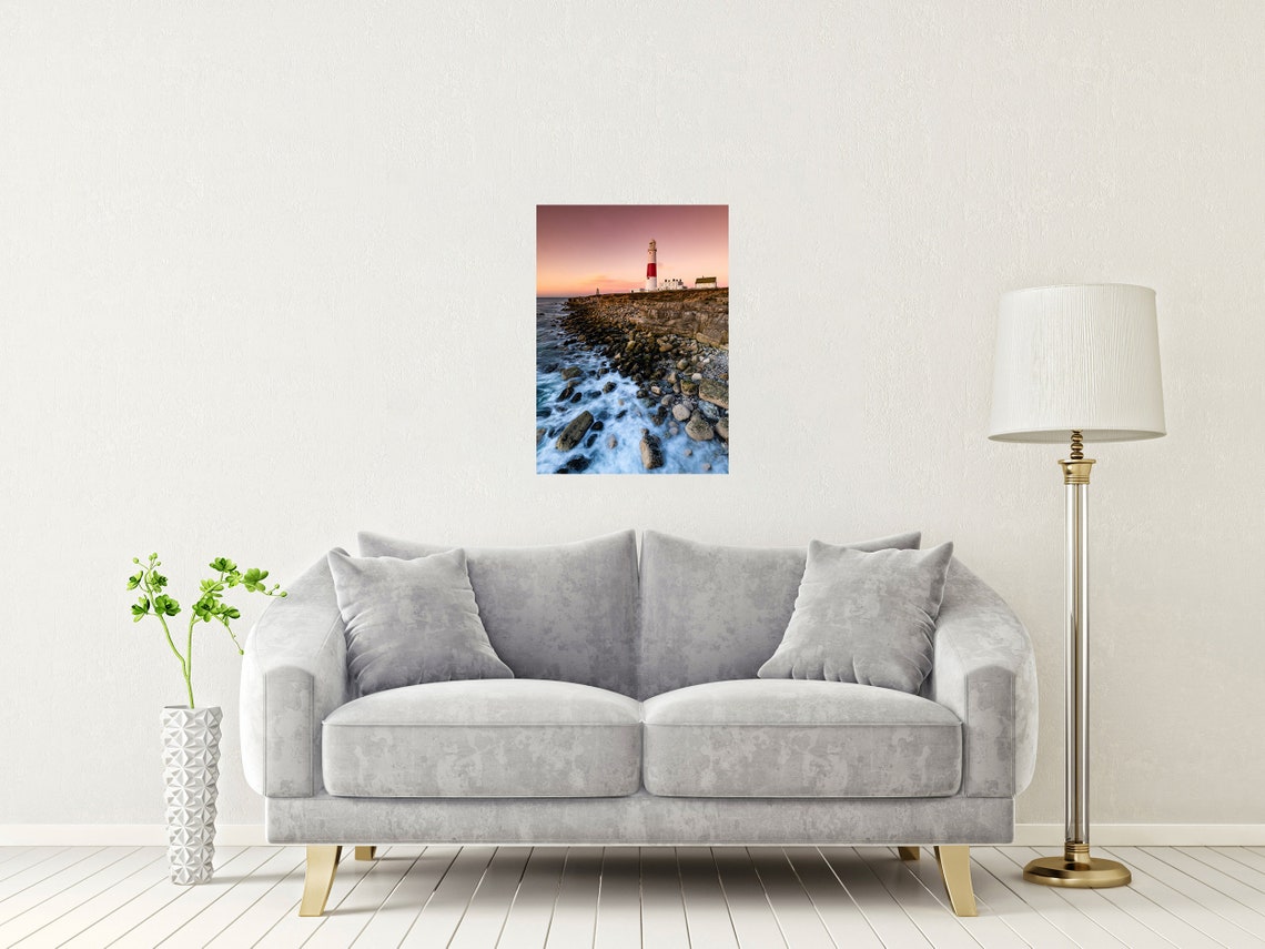 Red and White Striped Lighthouse on a Rocky Coast at Sunset Poster - Image 2