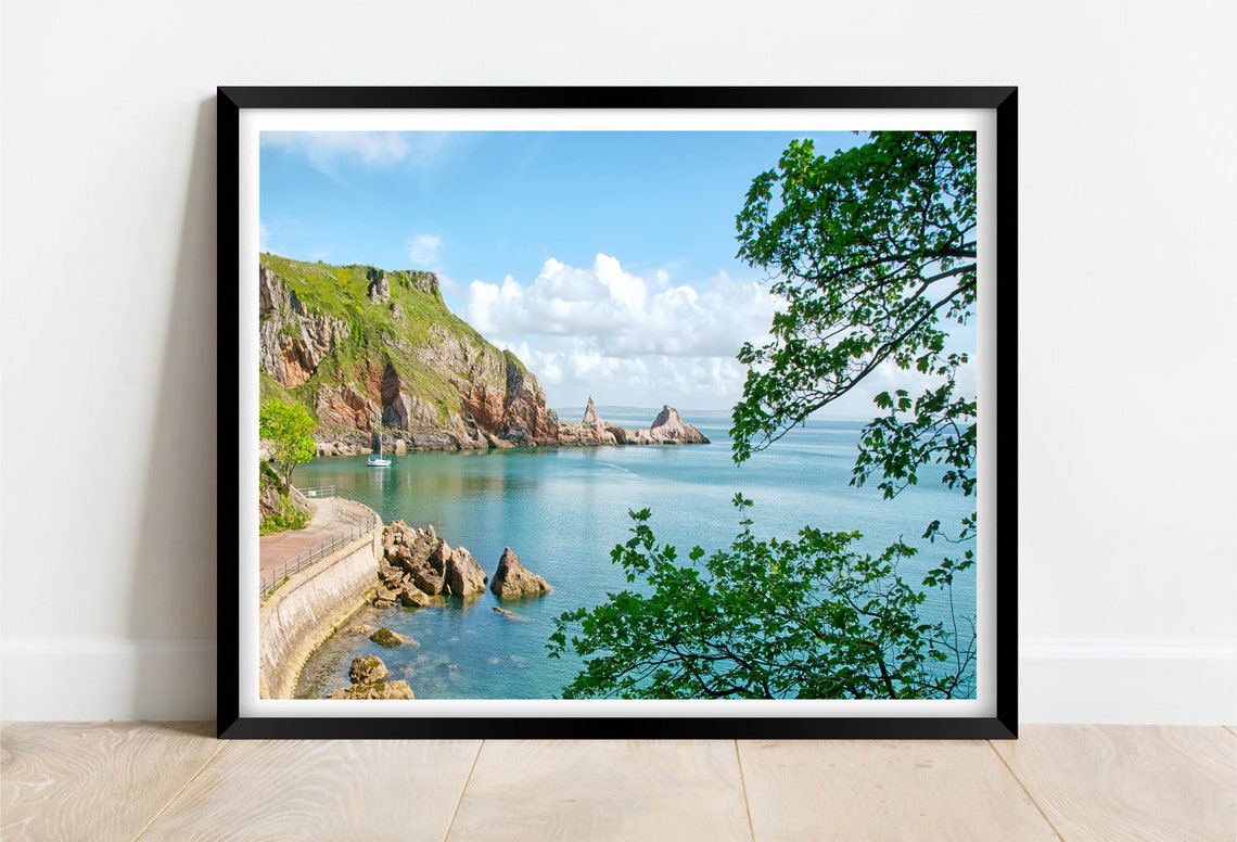 Rocky Headland With Sea Stacks and a Calm Blue Sea in Summer Poster