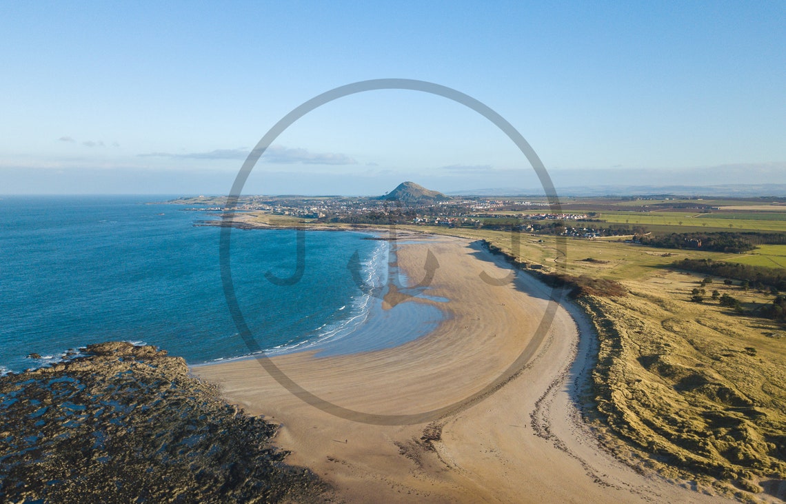 Aerial View of a Curving Sandy Beach Sweeping Around a Bay Poster - Image 3