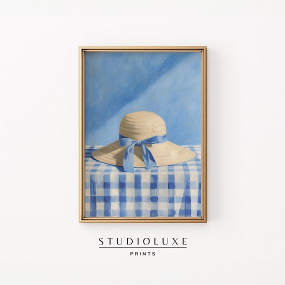 Straw Sun Hat with Blue Ribbon Bow on Gingham Table Cloth Poster