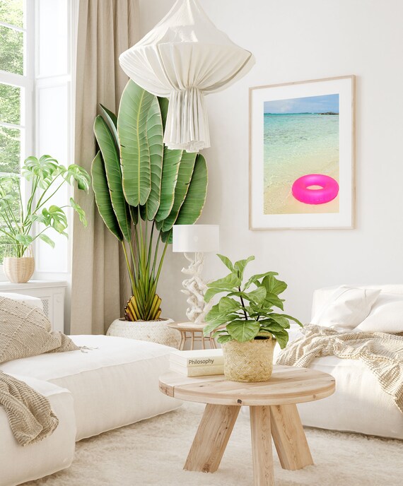 Pink Swim Ring Floating on Shallow Turquoise Beach Water Poster