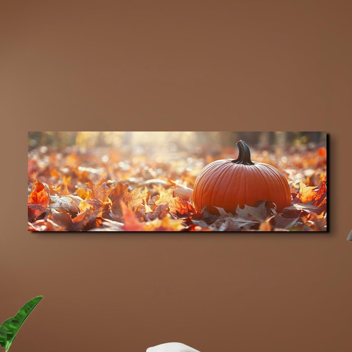 Single Pumpkin Resting in Golden Autumn Leaves Under Soft Sunlight Poster