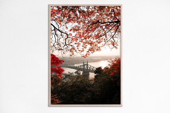 Red Autumn Trees Framing Historic Steel Bridge River View Poster