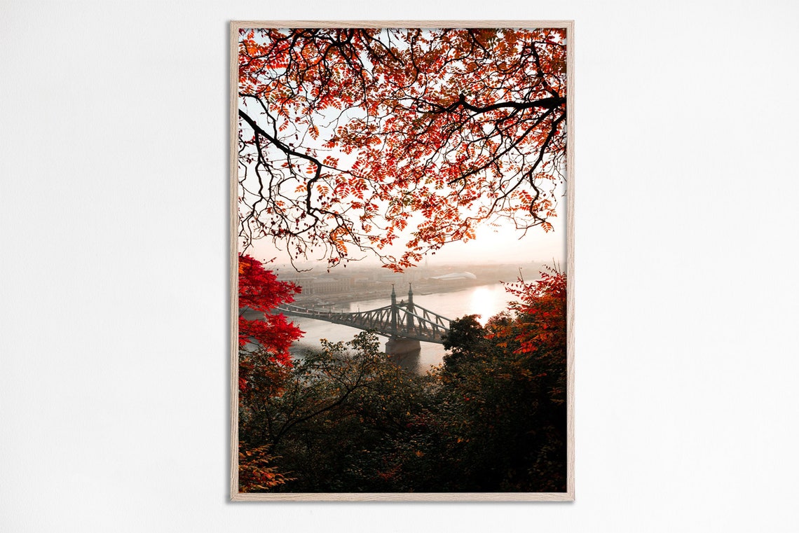 Red Autumn Trees Framing Historic Steel Bridge River View Poster