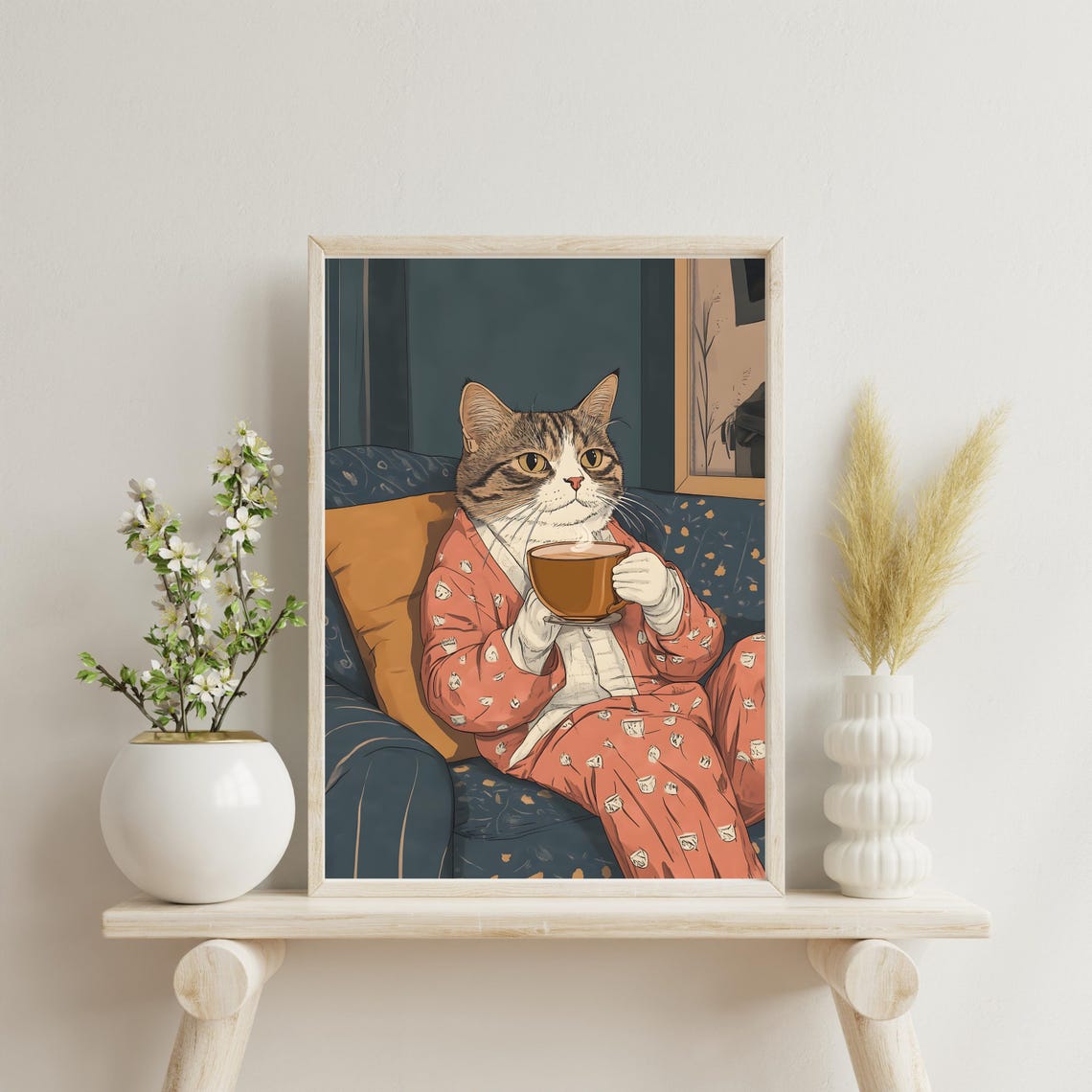 Cozy Tabby Cat in Pajamas Drinking Coffee on a Blue Sofa Poster - Image 3