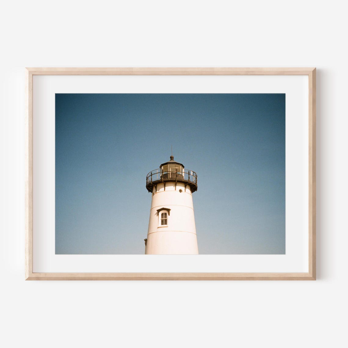 White Lighthouse Tower Rising Against a Clear Blue Sky Poster