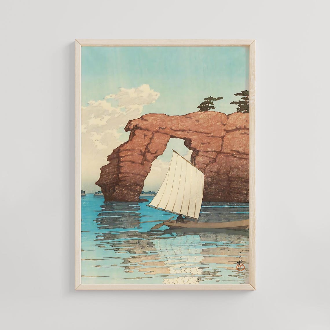 Sailboat Gliding Beneath a Coastal Rock Arch on Blue Water Print