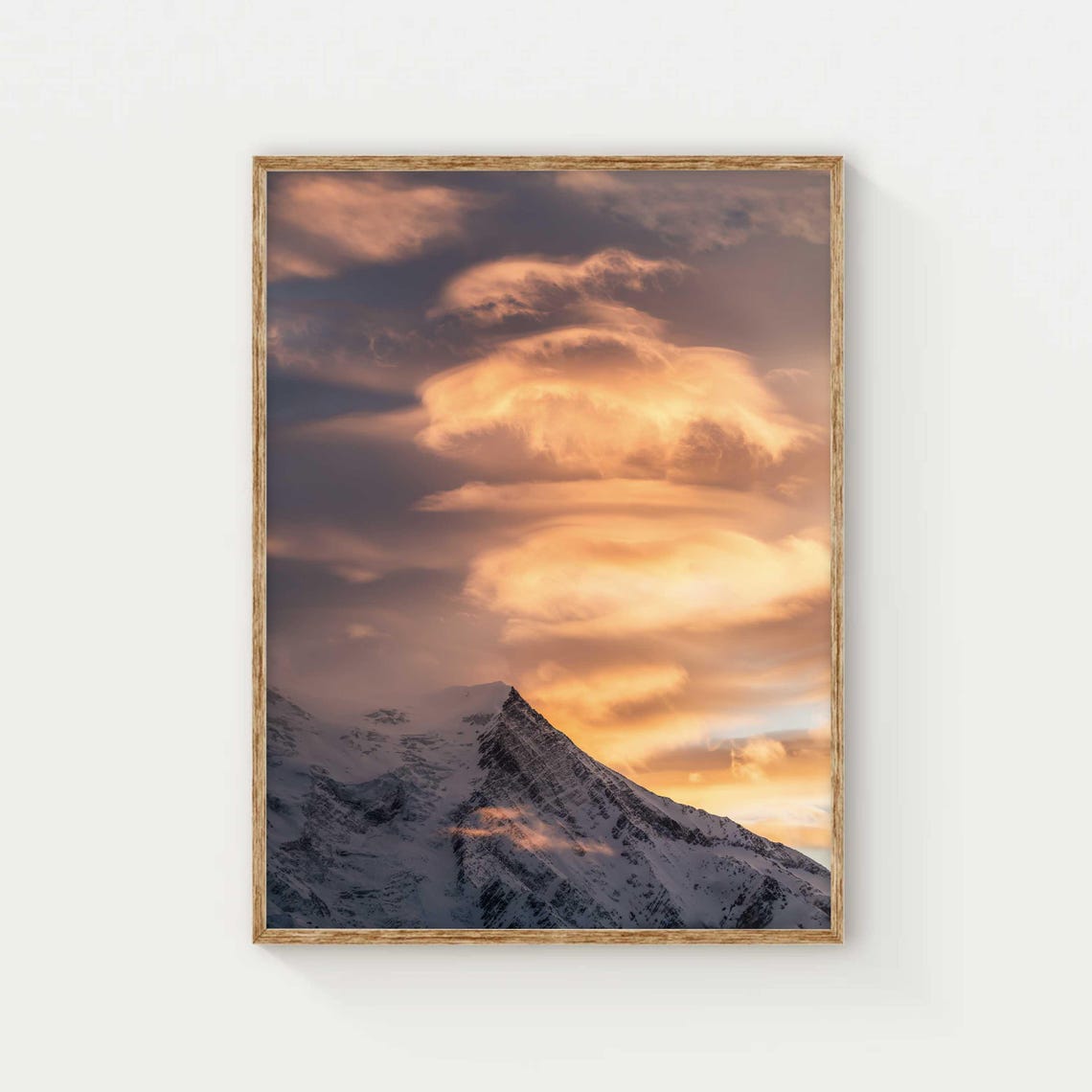 Lenticular Clouds Over a Snowy Peak at Golden Sunset Sky Poster