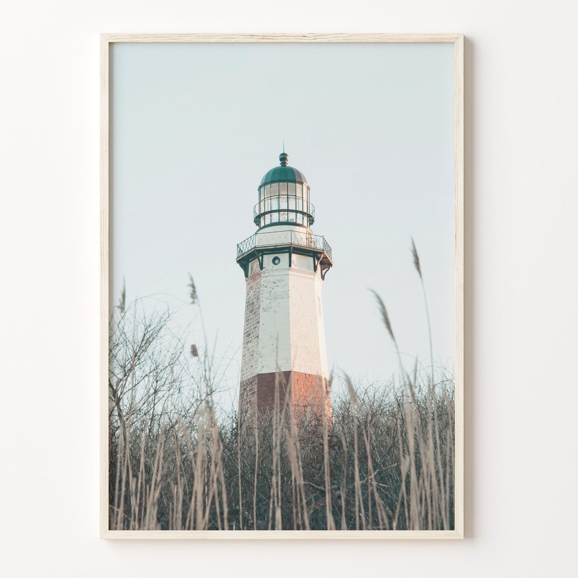 Lighthouse Seen Through Beach Grass In Pale Morning Light Poster