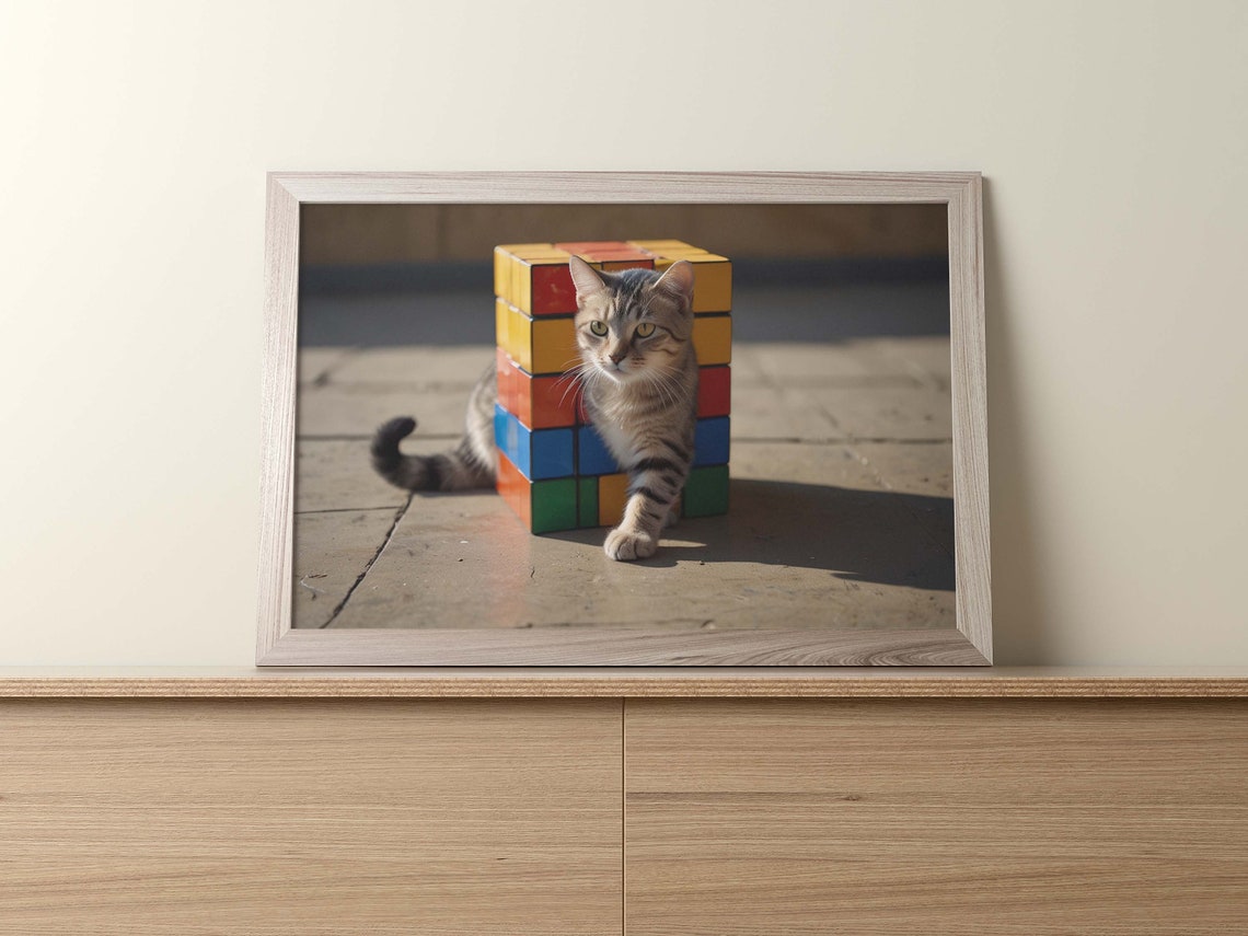 Tabby Cat Beside A Tall Stack Of Rubiks Cubes In Sunlight Poster - Image 2
