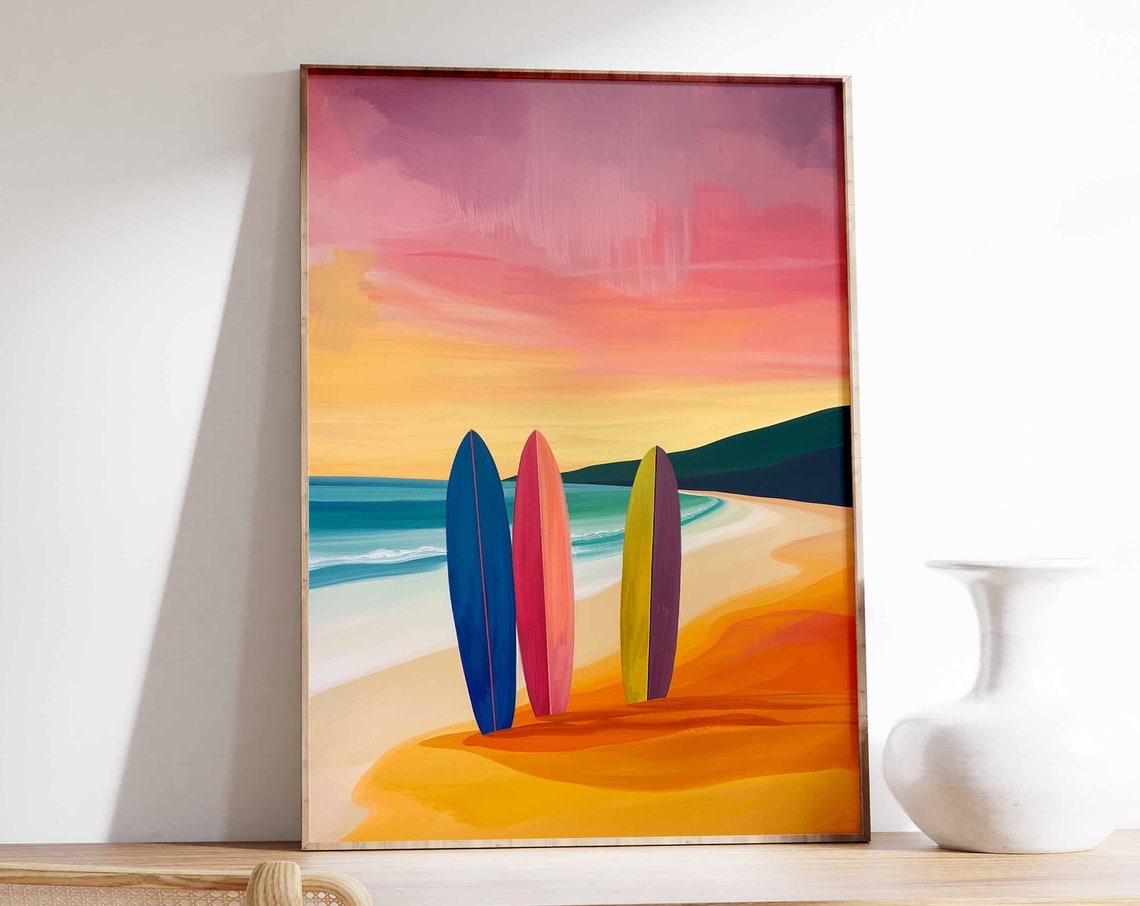 Three Colorful Surfboards on a Golden Beach at Sunset Poster