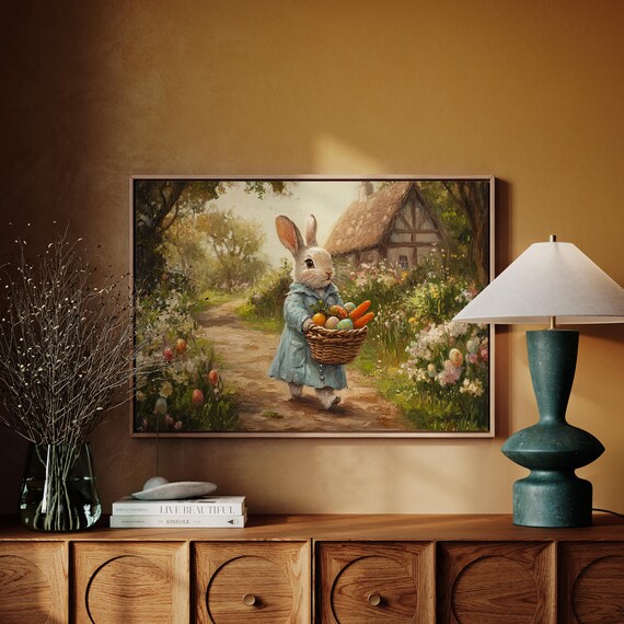 Bunny in Blue Coat Carrying Harvest Basket Toward Cottage Poster