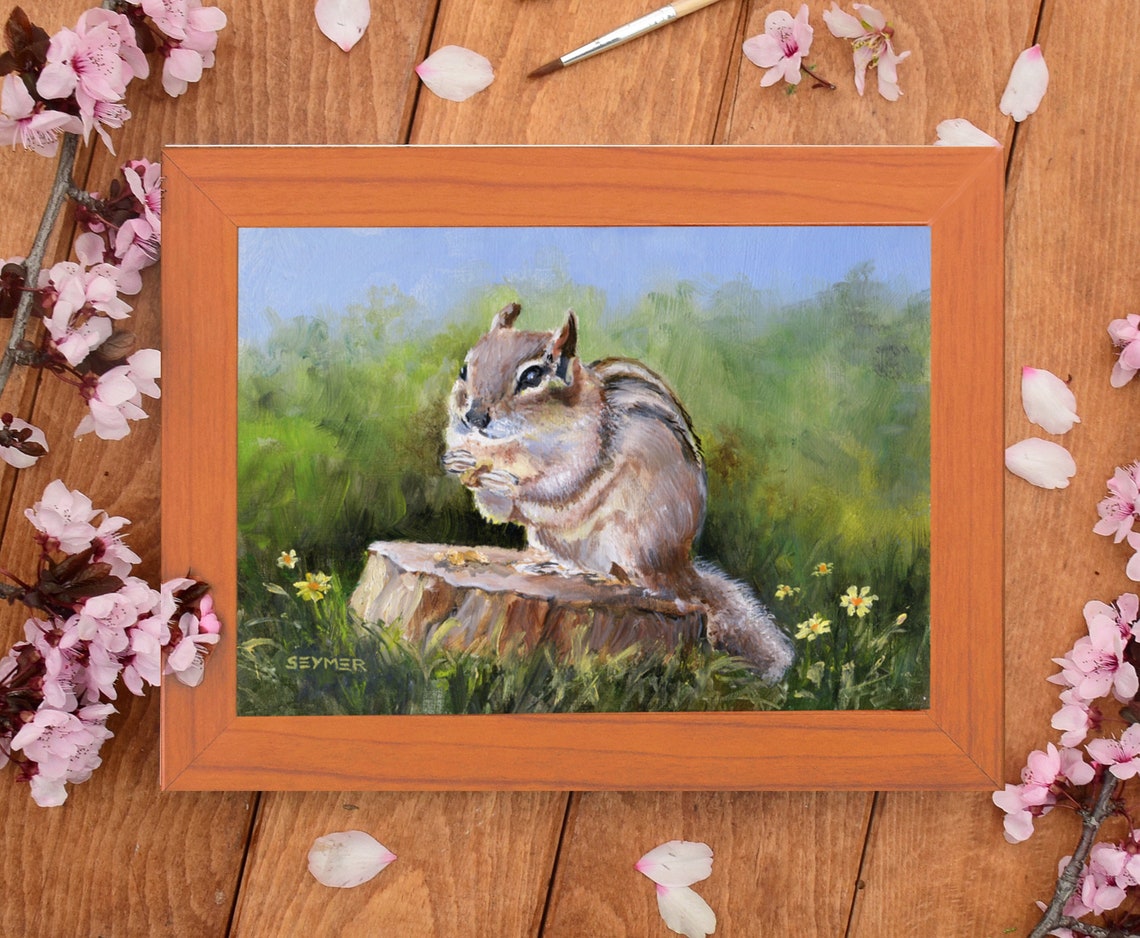 Cute Striped Chipmunk Sitting on a Tree Stump in a Sunny Meadow Poster - Image 5