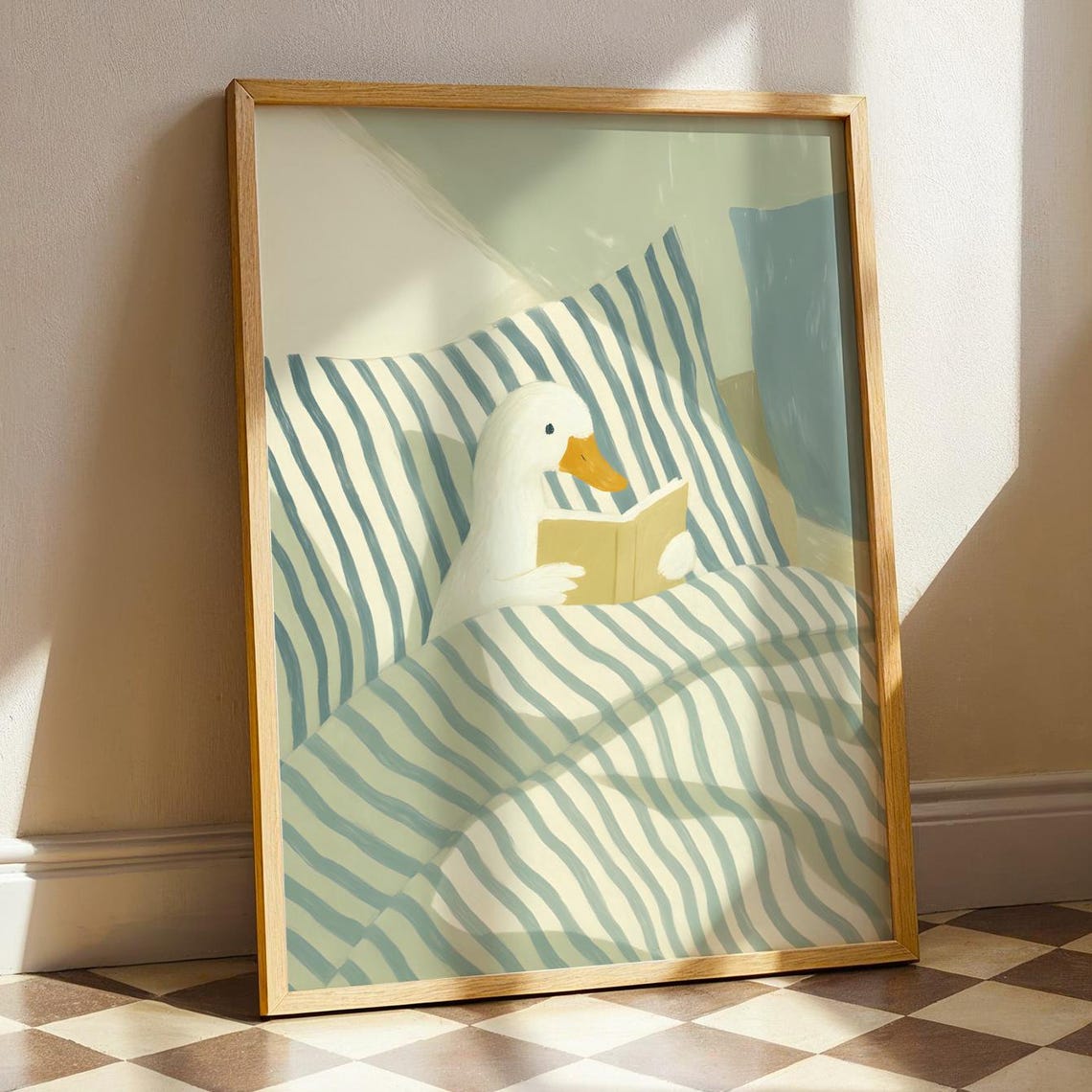 White Goose Reading a Book in Bed Under Striped Blanket Poster