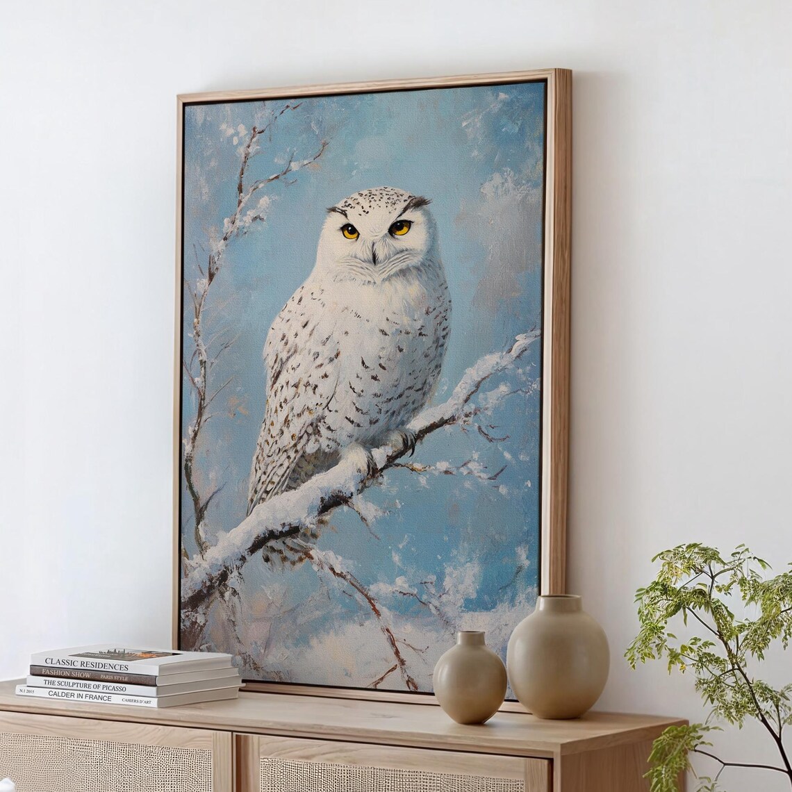 White Snowy Owl on Snowy Branch Against Pale Blue Sky Art Print
