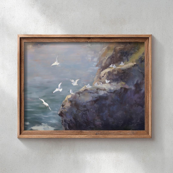 Seagulls Flying Over A Rugged Coastal Cliff In Soft Blue Poster