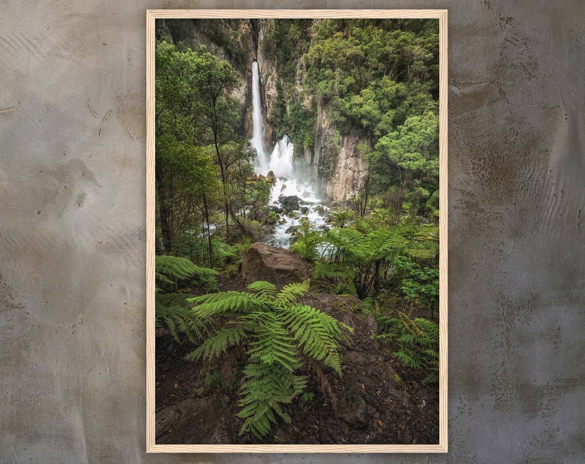 Towering Rainforest Waterfall With Lush Ferns And Green Jungle Poster