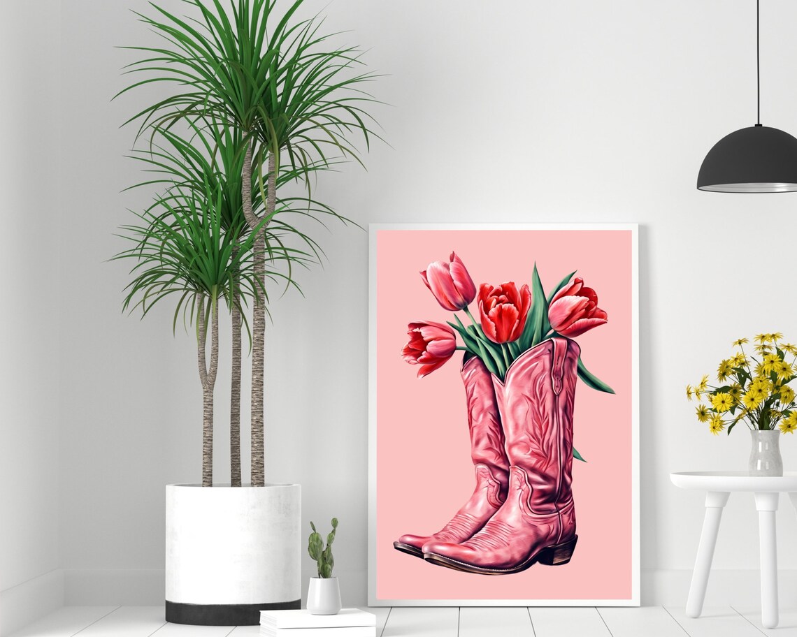 Pair Of Pink Cowboy Boots Holding Red Tulips On Pink Background Poster - Image 2