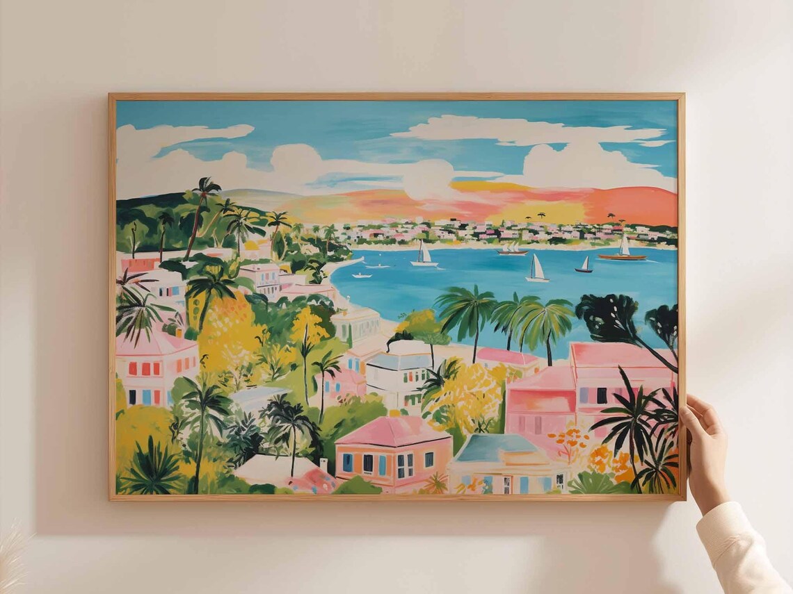 Pink Skied Coastal Town With Sailboats And Distant Mountains Poster