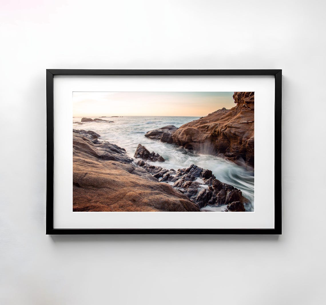 Rocky Sea Cliffs at Sunset as Soft Waves Roll In Coastal Poster