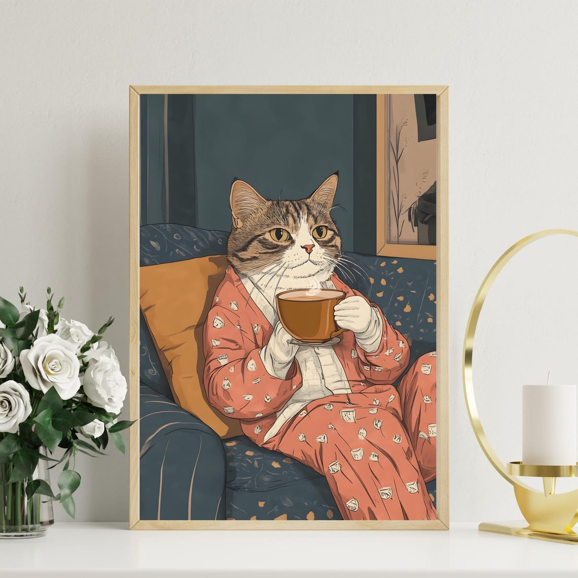Cozy Tabby Cat in Pajamas Drinking Coffee on a Blue Sofa Poster - Image 2