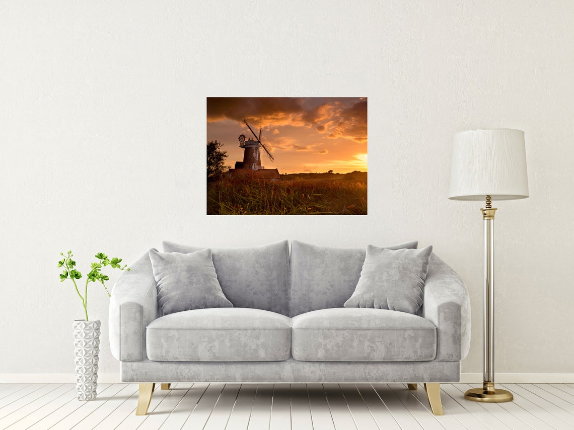 Historic Windmill Silhouetted Against a Fiery Orange Sunset Sky Poster - Image 2
