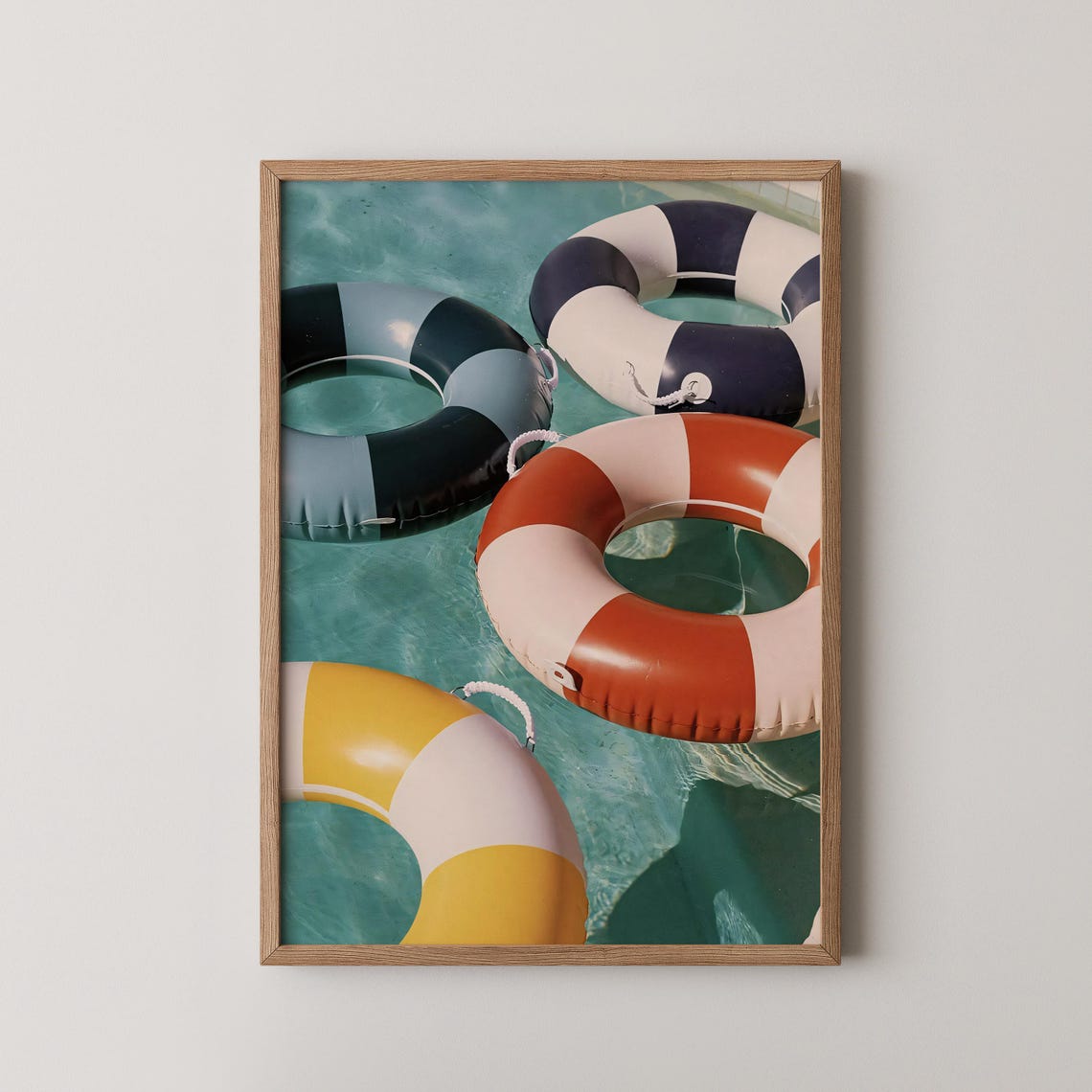 Retro Striped Inflatable Pool Floats Floating In Blue Water Poster