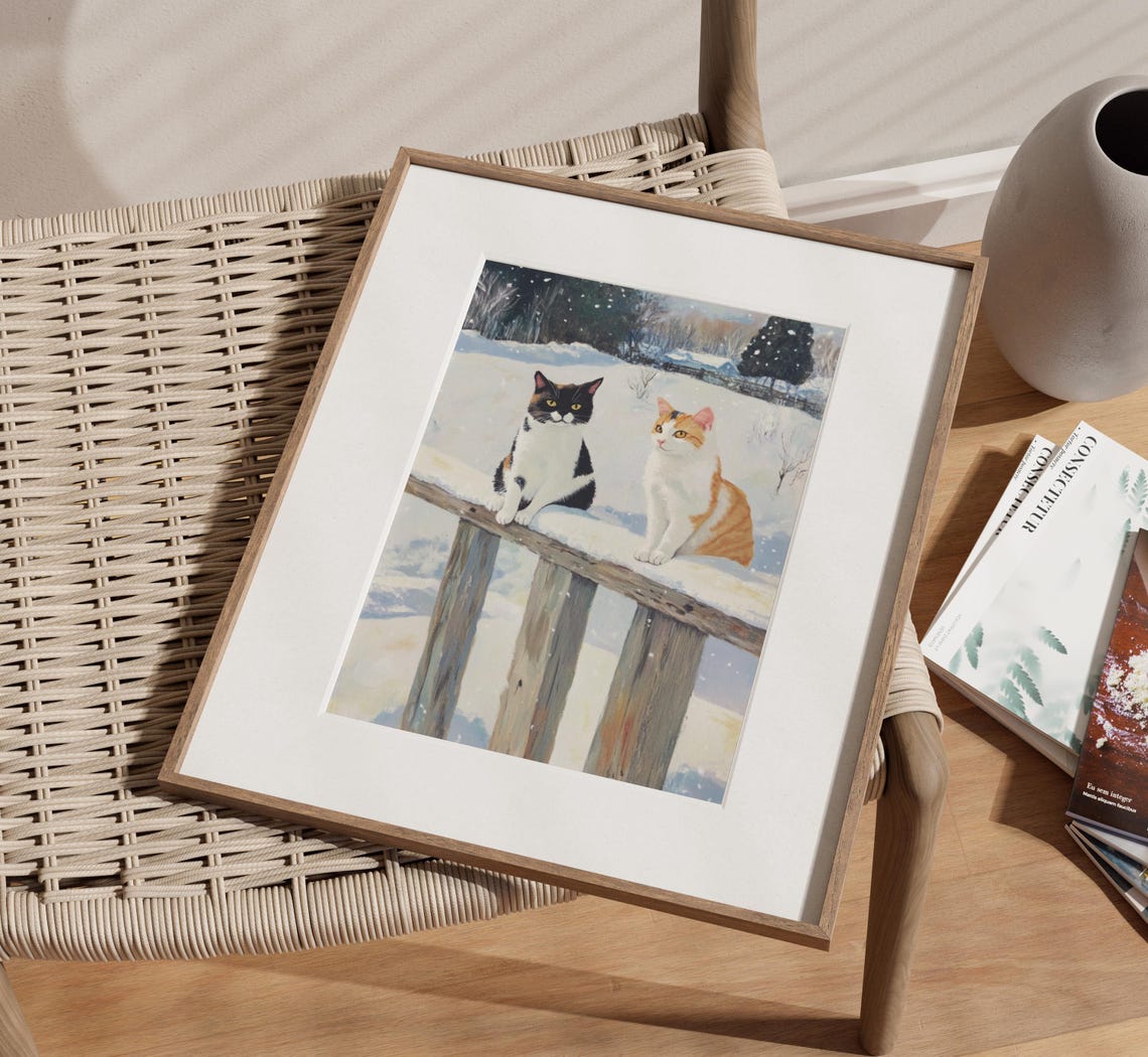 Two Cats Sitting on a Snow Covered Fence in Winter Village Poster - Image 2