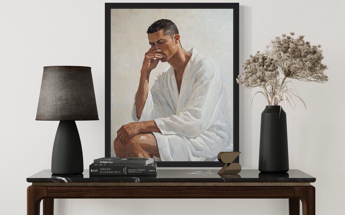 Young Man in White Robe Holding Nose in Funny Seated Pose Poster - Image 3