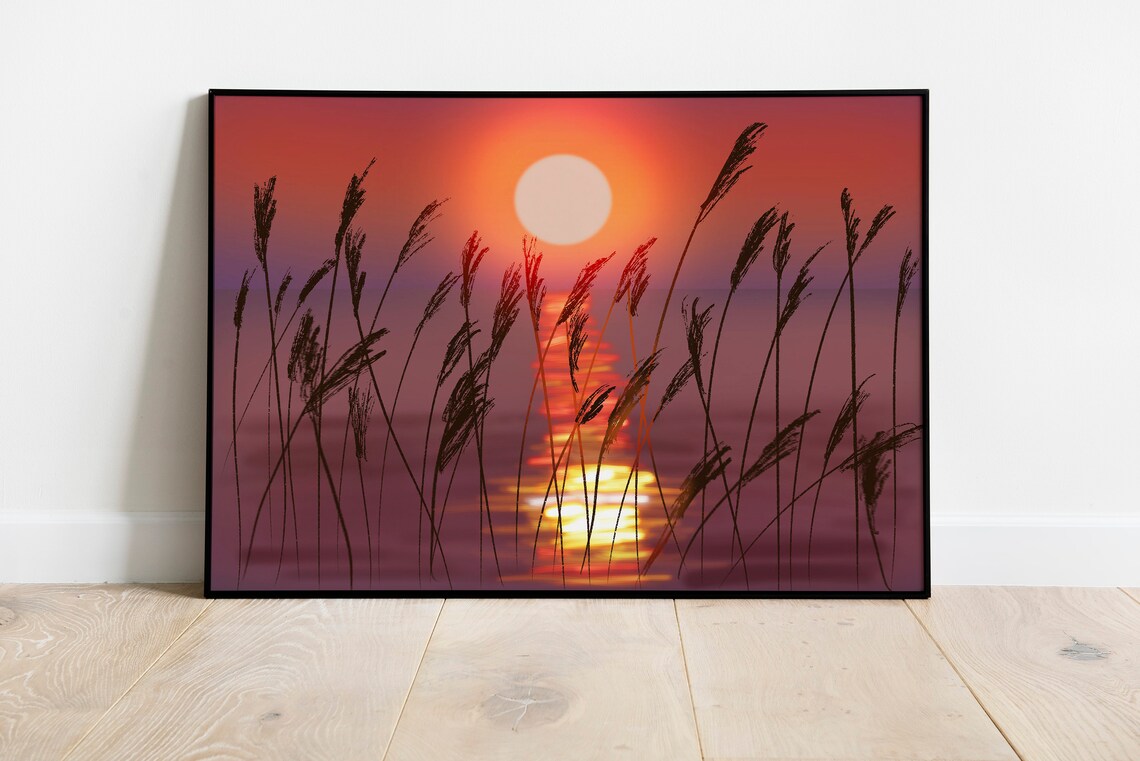 Fiery Red Sunset Over Calm Water with Reed Silhouettes Poster