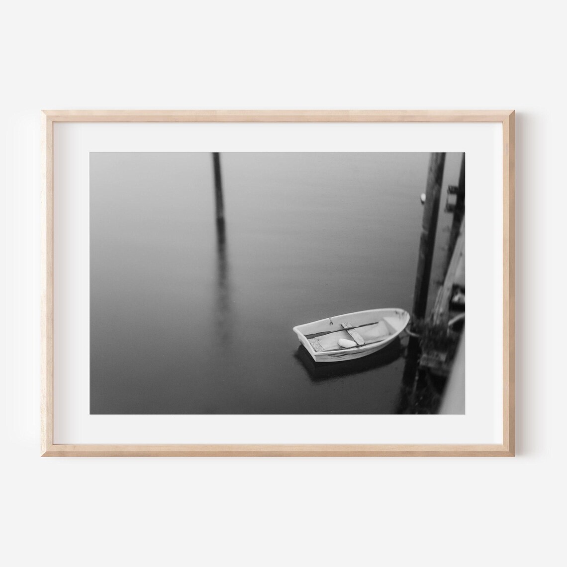 Lone Rowboat Moored at a Dock in Black and White Photo Poster