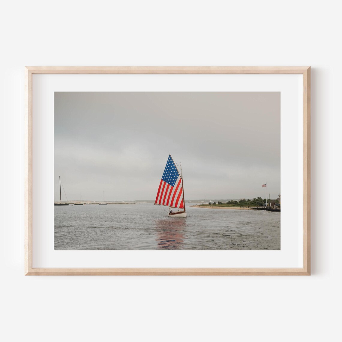 Sailboat With an American Flag Sail Gliding Across the Harbor Poster