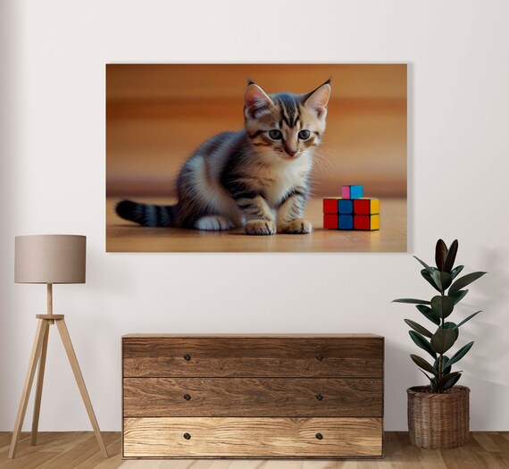 Curious Gray Tabby Kitten Sitting Beside Tiny Rubik Cube Toy Poster
