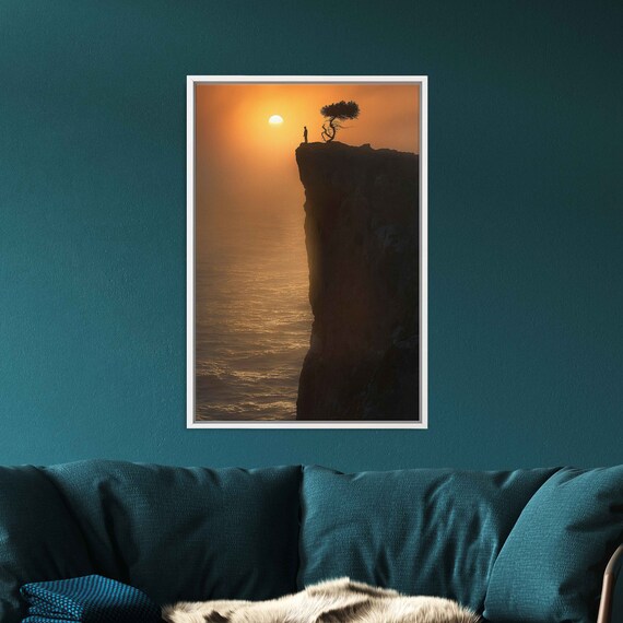 Lone Figure On Cliff Edge With Tree Silhouette Over Ocean Sunset Wall Art