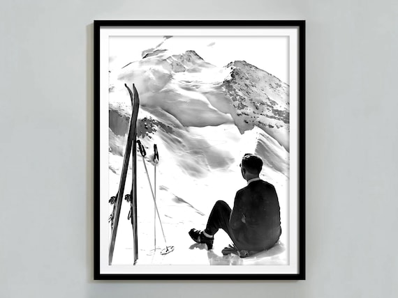 Man Sitting On Snowy Mountain Peak Gazing At Winter Summit Views Poster