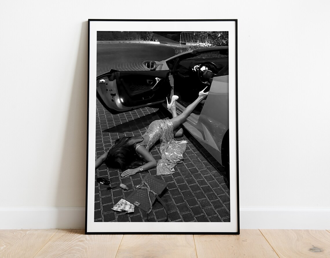 Woman Lying on Ground by Open Door Sports Car Fashion Photo Poster - Image 2