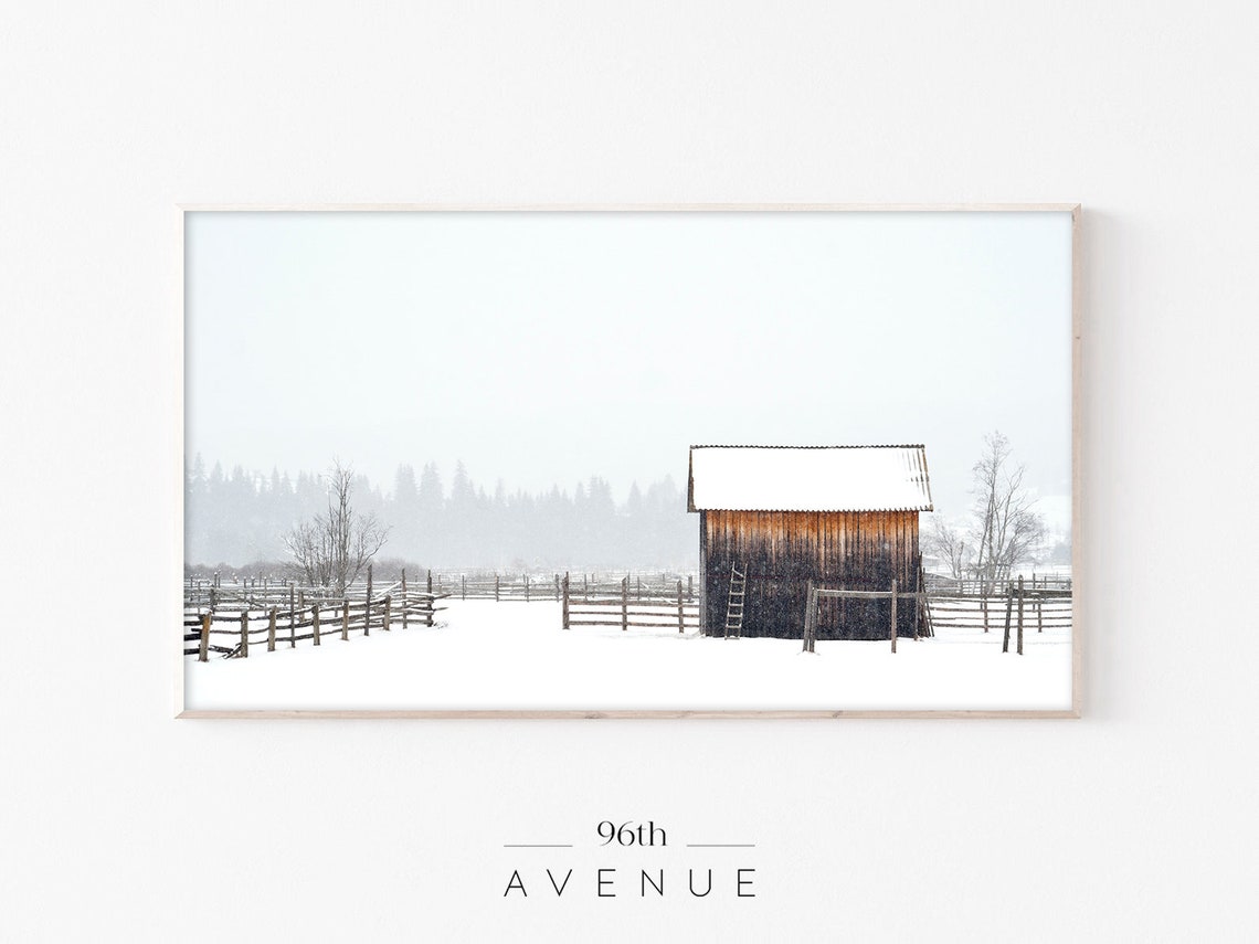 Rustic Wooden Barn in a Snowstorm with Wooden Fences Winter Poster