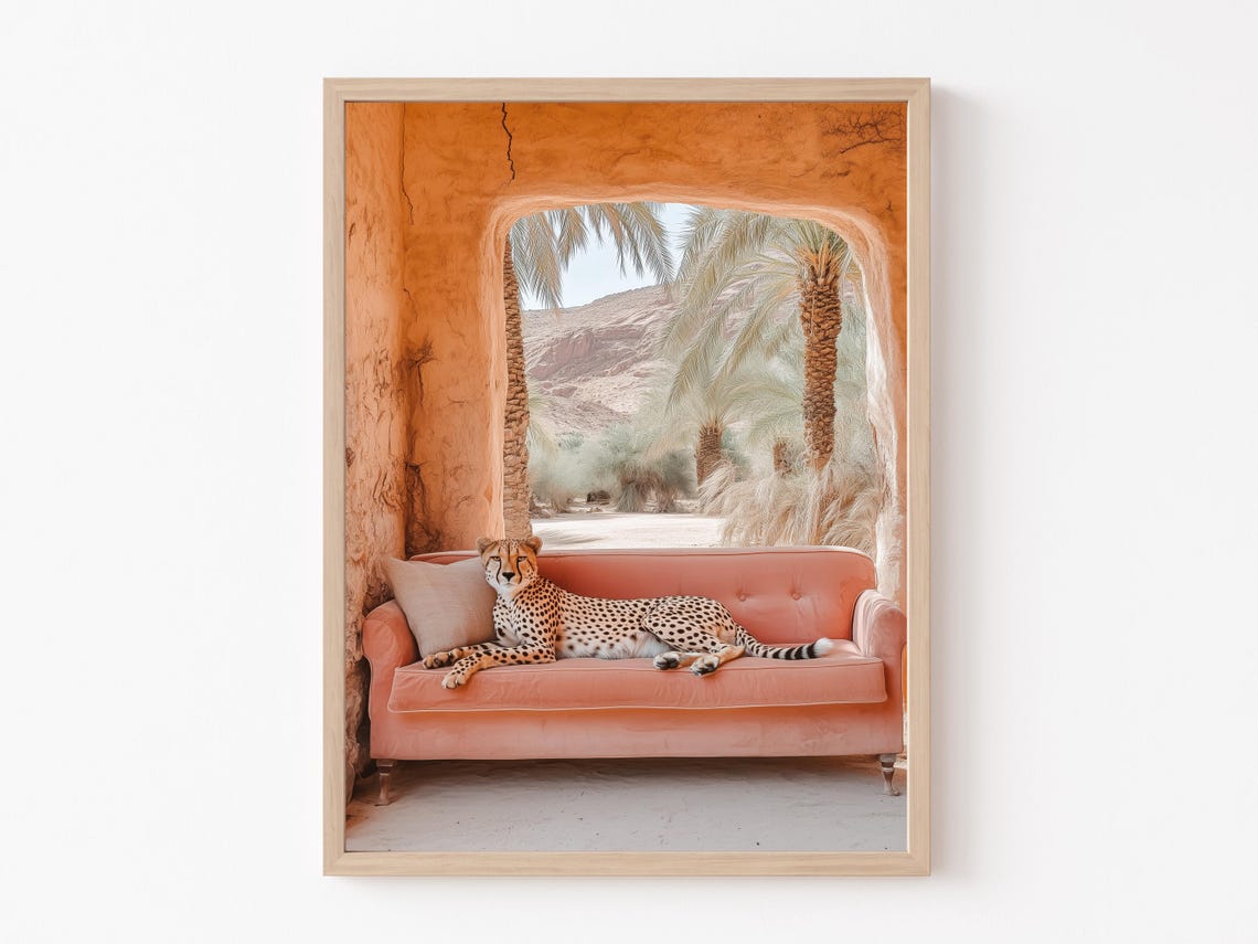 Whimsical Cheetah Lounging on a Pink Sofa in a Desert Arch Poster