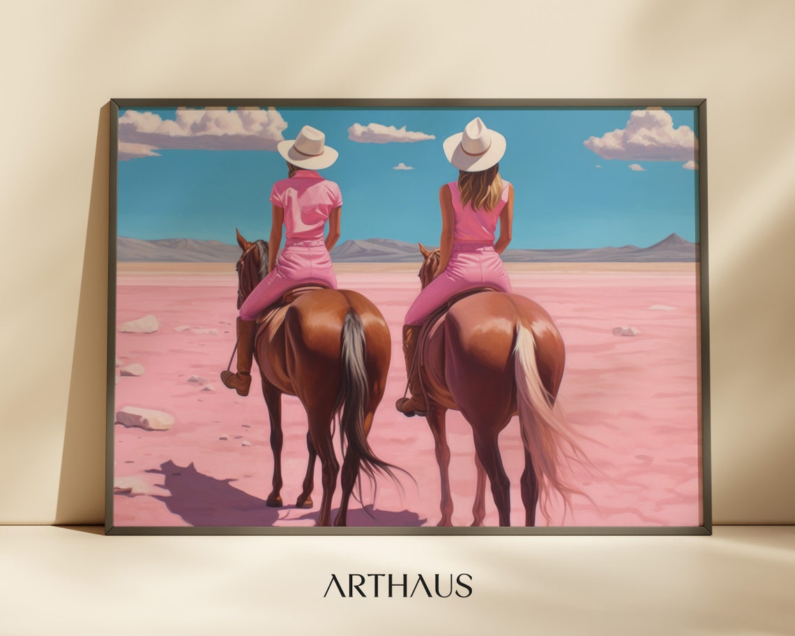 Two Cowgirls Riding Horses Across A Dreamy Pink Desert Poster