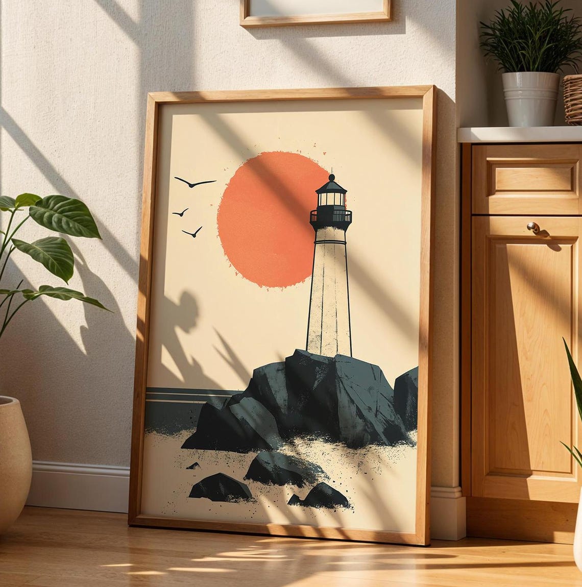 Minimalist Lighthouse on Rocky Shore Under a Big Orange Sun Poster