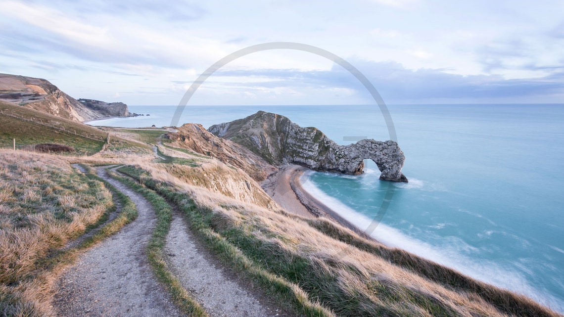 Durdle Door Limestone Arch With a Winding Coastal Path at Dawn Poster - Image 3