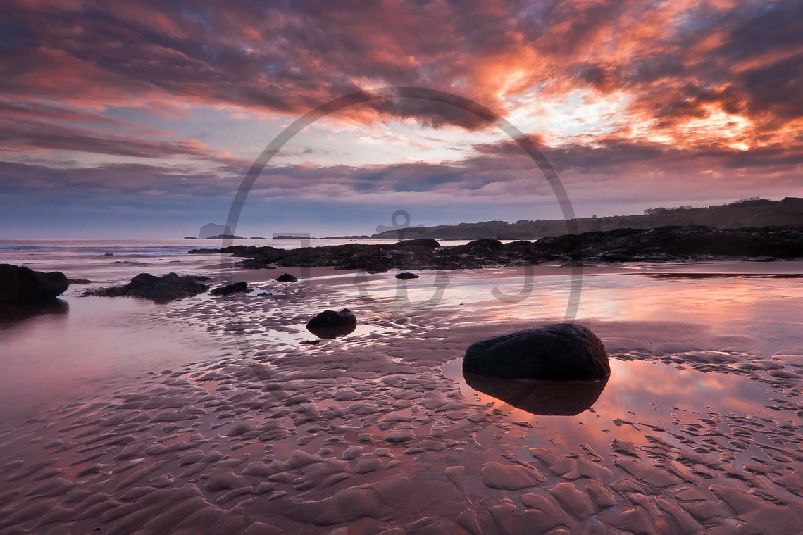 Crimson Sunset Over Wet Sand and Rocks with Reflections Poster - Image 3