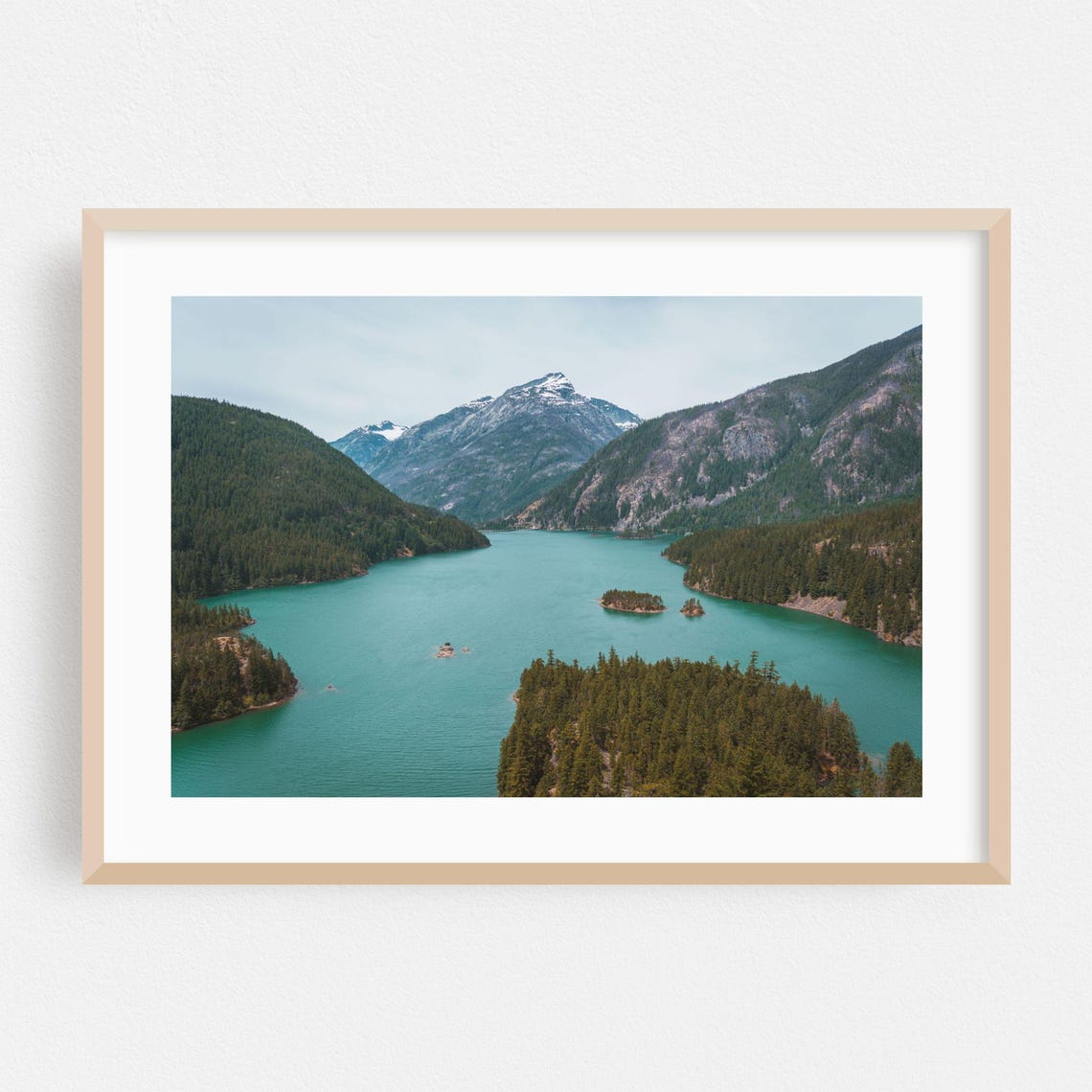Turquoise Alpine Lake Ringed by Forested Mountain Peaks Poster