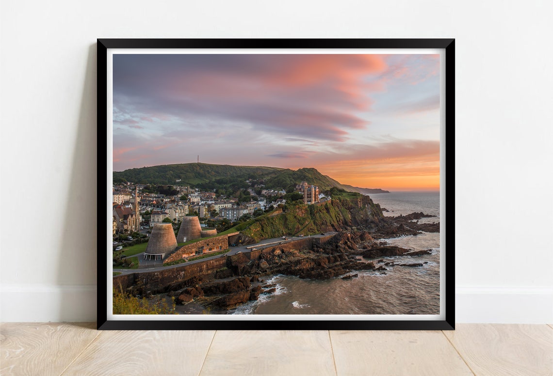 Ilfracombe Devon Sunset Over Cliff Town And Rocky Coastline Poster