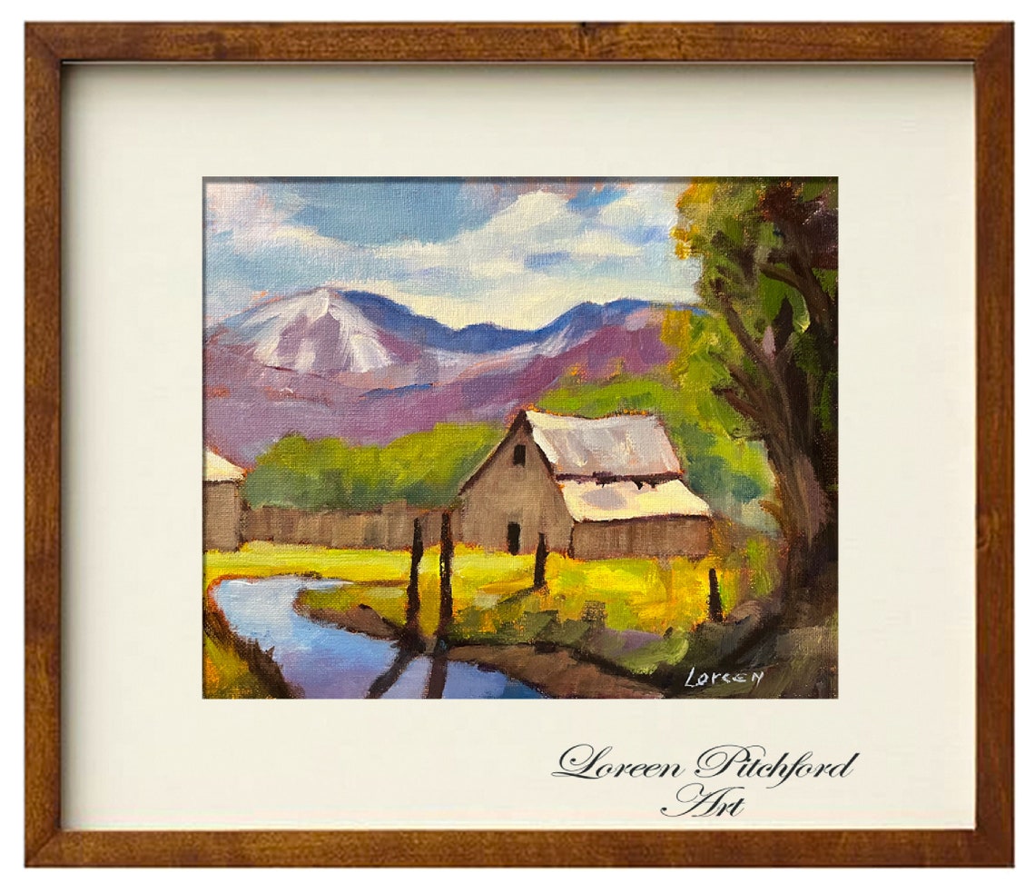 Small Rustic Barn Beside a Stream with a Snowy Peak Behind Poster